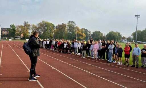 Na zdjęciu uczniowie na stadionie miejskim pozują do zdjęcia.